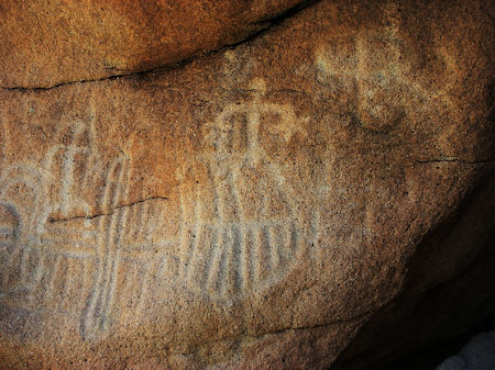 Inside a shallow cave are deeply carved petroglyphs in Baja. 